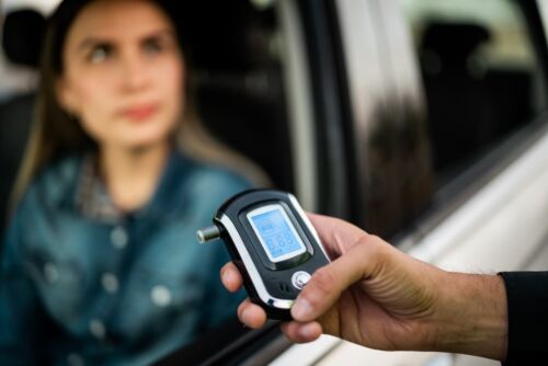 Close-up of traffic cop holding driving alcohol test