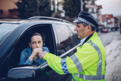 Police man giving woman an alcohol test